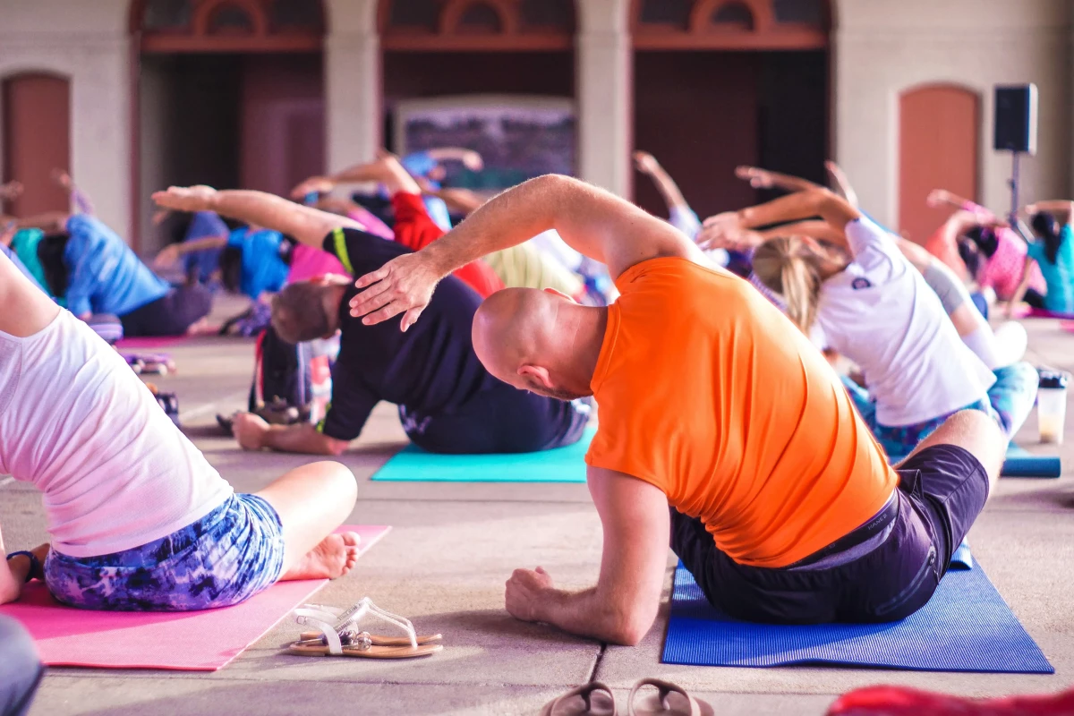 Group of people doing gentle exercises on the floor in a studio