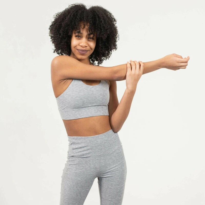 Young woman in sports bra and three quarter length leggins